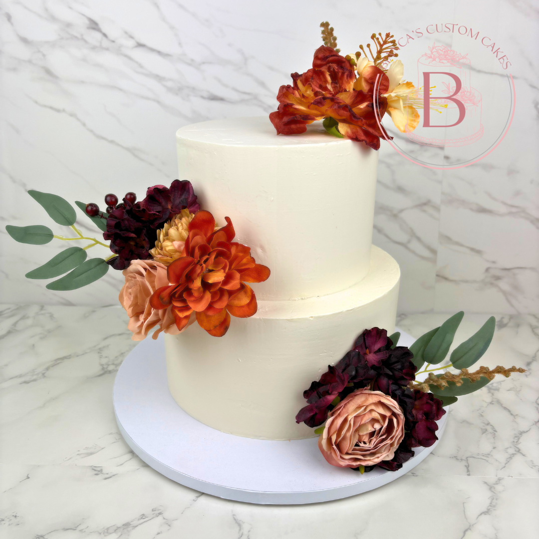 simple buttercream cake with faux flowers